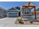 Charming home featuring a stone-accented porch, blue siding, and a well-manicured, low maintenance landscape at 11494 Colony Loop, Parker, CO 80138