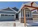 Charming home featuring a stone-accented porch, blue siding, and a well-manicured, low maintenance landscape at 11494 Colony Loop, Parker, CO 80138