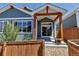 Charming home entrance with timber support, wooden fence, and rock landscaping at 11494 Colony Loop, Parker, CO 80138