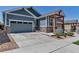 Charming home with a well-manicured lawn, attached garage, and beautiful stone accents at 11494 Colony Loop, Parker, CO 80138