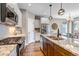 Modern kitchen featuring granite countertops, stainless steel appliances, white cabinets, and tile backsplash at 11494 Colony Loop, Parker, CO 80138