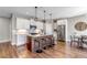 Modern kitchen featuring white cabinets, stainless steel appliances, and a central island with bar seating at 11494 Colony Loop, Parker, CO 80138