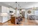 Open concept kitchen with island seating, stainless steel appliances, and an adjacent dining area at 11494 Colony Loop, Parker, CO 80138