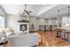 Open-concept living area showcasing a fireplace and seamless flow to the kitchen at 11494 Colony Loop, Parker, CO 80138