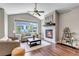 Cozy living room with vaulted ceilings, a fireplace, and large windows offering ample natural light at 11494 Colony Loop, Parker, CO 80138