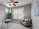 Bright home office with a ceiling fan, desk, chair, and large window with plantation shutters at 11494 Colony Loop, Parker, CO 80138