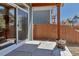 Covered patio with gray siding, natural wood supports, and a wooden fence at 11494 Colony Loop, Parker, CO 80138