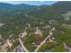 Aerial view of a house nestled in a mountainous forest area at 28 Deer Rd, Evergreen, CO 80439