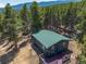 Single story home aerial view with deck at 28 Deer Rd, Evergreen, CO 80439