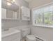 Clean bathroom with white vanity, toilet and bathtub shower combo at 28 Deer Rd, Evergreen, CO 80439