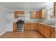 Nice kitchen with wood cabinets, stainless steel appliances, and vinyl flooring at 28 Deer Rd, Evergreen, CO 80439