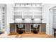 Dedicated home office area with built-in shelving, a workspace for two, and hardwood floors at 3059 Curtis St, Denver, CO 80205