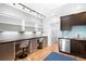 Functional home office space featuring built-in shelving, a workspace for two, and modern lighting at 3059 Curtis St, Denver, CO 80205
