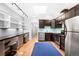 Contemporary kitchen with stainless steel appliances, a built-in desk, and a well-lit design at 3059 Curtis St, Denver, CO 80205