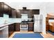 Well-equipped kitchen with stainless steel appliances, ample counter space, and a seamless transition to the living area at 3059 Curtis St, Denver, CO 80205