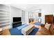 Open-concept living room with built-in shelving, modern furnishings, and a seamless flow to the kitchen at 3059 Curtis St, Denver, CO 80205