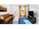 Bright living room featuring a comfortable couch, stylish decor, and natural light from the window at 3059 Curtis St, Denver, CO 80205