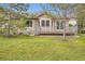 A beautiful backyard featuring a well-maintained lawn and a spacious wooden deck at 6132 Terry Ct, Arvada, CO 80403