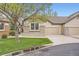 Charming home exterior featuring a well-manicured lawn and a two-car garage at 6132 Terry Ct, Arvada, CO 80403