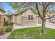Charming home with beige siding, brick accents, and a well-maintained lawn at 6132 Terry Ct, Arvada, CO 80403