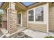 Inviting covered porch with brick columns and decorative wreath at 6132 Terry Ct, Arvada, CO 80403