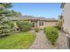 Charming front yard landscaping with gravel walkway, bushes, and well-kept lawn at 6132 Terry Ct, Arvada, CO 80403