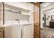 Well-organized laundry room with washer, dryer, shelving, and direct access to a bathroom at 6132 Terry Ct, Arvada, CO 80403