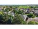 Aerial view showcases a residential area, adjacent park, and greenery, offering community charm at 9845 Keenan St, Highlands Ranch, CO 80130
