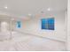 Bright basement space featuring neutral carpet, and window wells for natural light at 9845 Keenan St, Highlands Ranch, CO 80130