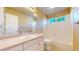 Clean bathroom featuring white vanity, tile surround bathtub and a large mirror at 9845 Keenan St, Highlands Ranch, CO 80130