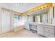 Luxurious bathroom with a soaking tub, glass shower, double vanity, and ample natural light at 9845 Keenan St, Highlands Ranch, CO 80130