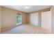 Well-lit bedroom with carpet flooring, double door closet, and a large window for natural light at 9845 Keenan St, Highlands Ranch, CO 80130
