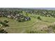 Community view with homes surrounding a vast green space and walking trails, ideal for outdoor living at 9845 Keenan St, Highlands Ranch, CO 80130