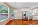 Bright breakfast nook with stainless steel refrigerator, hardwood floors, and large windows at 9845 Keenan St, Highlands Ranch, CO 80130