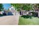 Charming home with a three-car garage, bay window, mature tree, and a well-manicured lawn at 9845 Keenan St, Highlands Ranch, CO 80130