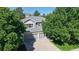 Two-story home features a three-car garage and beautiful landscaping in a lush, green setting at 9845 Keenan St, Highlands Ranch, CO 80130