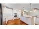 Modern kitchen featuring white cabinetry, stainless steel appliances, and hardwood floors at 9845 Keenan St, Highlands Ranch, CO 80130
