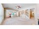 Open-concept living space with a glimpse of the kitchen, staircase, and a tiled fireplace at 9845 Keenan St, Highlands Ranch, CO 80130