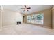 Bright living room with a cozy fireplace, built-in shelves, and three large windows overlooking the backyard at 9845 Keenan St, Highlands Ranch, CO 80130