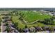 Neighborhood view with a large green park area adjacent to residential homes and paved walkways at 9845 Keenan St, Highlands Ranch, CO 80130