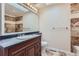 Well-lit bathroom with tile floor, stone accents, vanity and sink with a large mirror at 11612 E Cornell Cir, Aurora, CO 80014