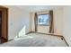Bright bedroom with neutral carpeting and a window providing natural light at 11612 E Cornell Cir, Aurora, CO 80014