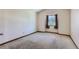 Bright bedroom with neutral carpeting and a window providing natural light at 11612 E Cornell Cir, Aurora, CO 80014