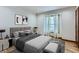 Cozy bedroom with neutral décor, modern furnishings, and a window offering natural light at 11612 E Cornell Cir, Aurora, CO 80014