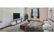 Cozy bedroom featuring plush carpeting, a modern TV console, and a comfortable queen-sized bed at 11612 E Cornell Cir, Aurora, CO 80014
