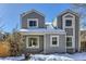 Gray two-story house with snow-covered roof and yard at 11612 E Cornell Cir, Aurora, CO 80014