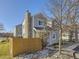 Gray house with stone chimney and fenced backyard at 11612 E Cornell Cir, Aurora, CO 80014
