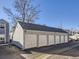 Detached six-car garage with white doors under a gray shingled roof; each bay is labeled with a letter at 11612 E Cornell Cir, Aurora, CO 80014