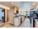 Compact kitchen with neutral cabinets, tile floors and adjacent dining area at 11612 E Cornell Cir, Aurora, CO 80014