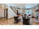 Bright living room with hardwood floors, fireplace and staircase featuring metal accents at 11612 E Cornell Cir, Aurora, CO 80014